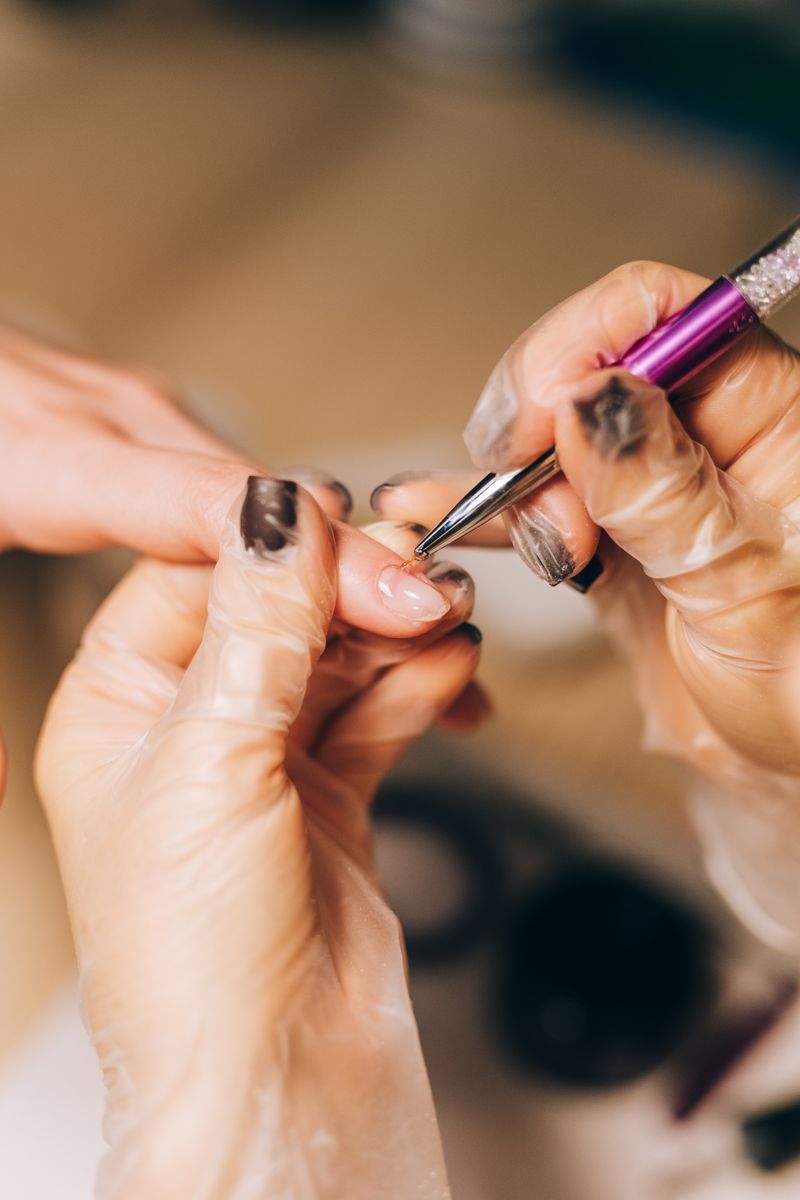 Manicurist applying polish at Noir Nail Bar